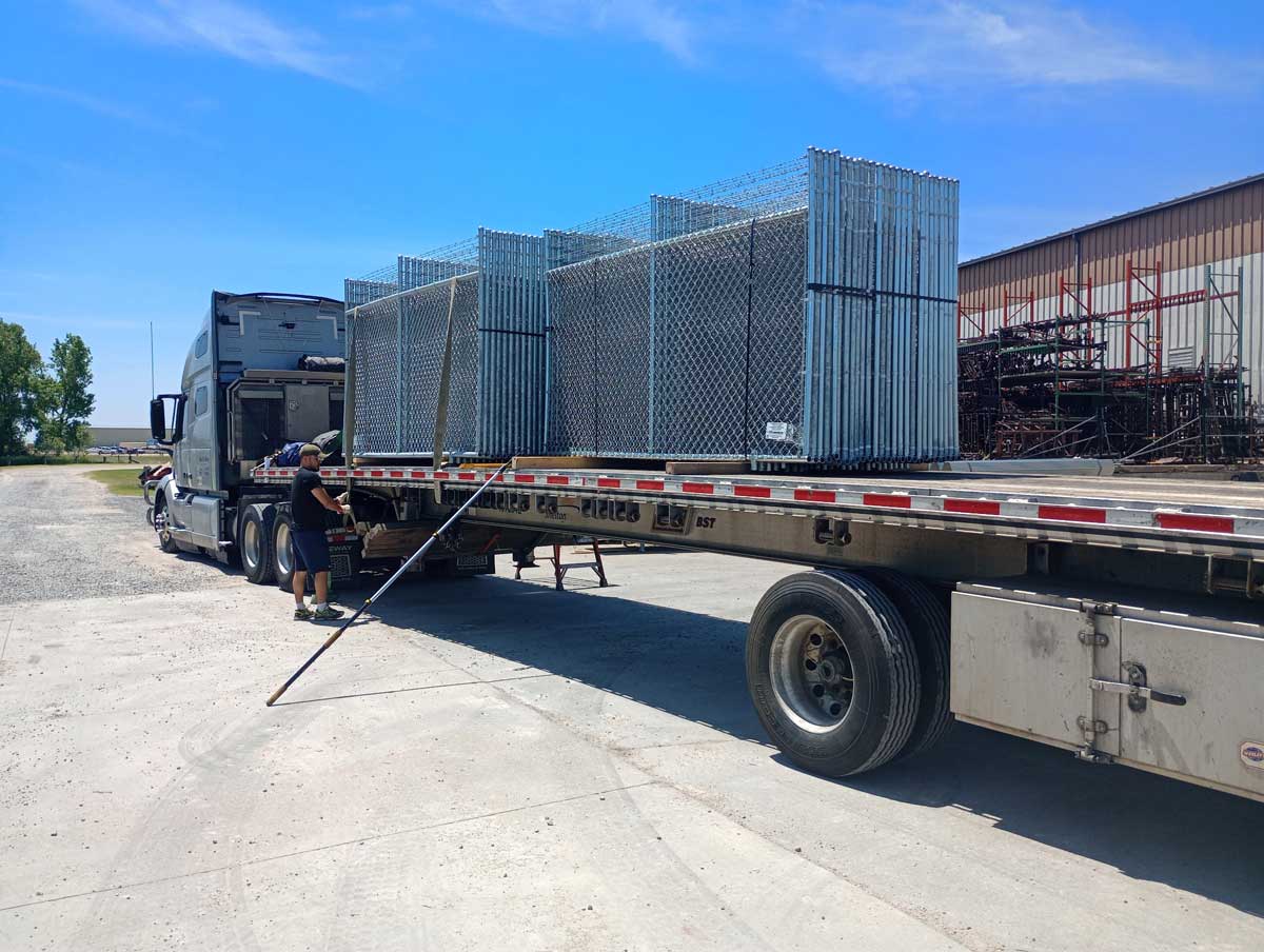 Barrier fence panels in transport to construction site