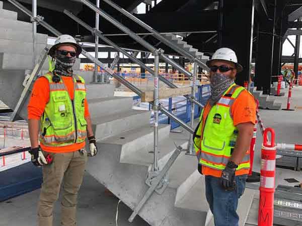 Construction workers with stair rail