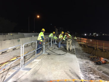 Construction workers at night setting up rails