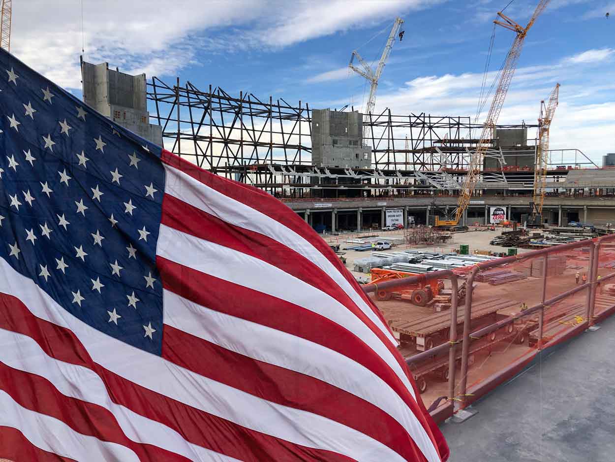 american flag infront of construction site