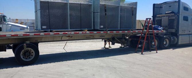 Barrier fence being transported to shipyard construction site